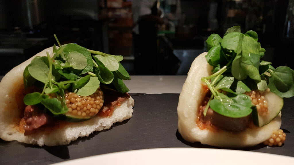 Kimchi flavored bao with pickled cucumbers and beef